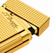 A close-up of an S. T. Dupont Ligne 2 pocket cigar lighter in a yellow gold-plated finish diamond-head guilloche pattern. Model 016284. A luxury soft-flame lighter for cigar smoking.