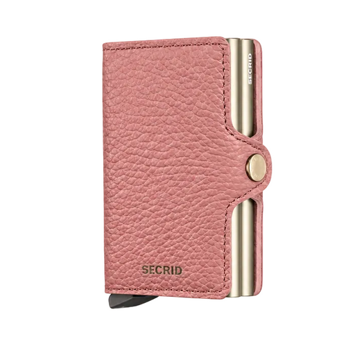 A pink pebbled leather Secrid Mini wallet with gold-tone metal accents and a snap-button closure, shown on a clean white background.