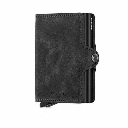 A black Secrid Twin Wallet made of vintage leather with two metal card protector and a snap closure.