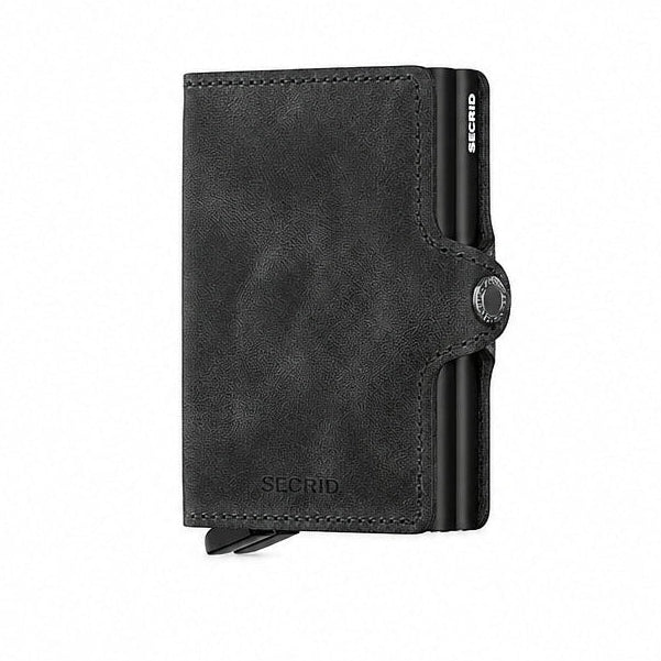 A black Secrid Twin Wallet made of vintage leather with two metal card protector and a snap closure.