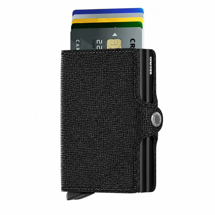 A black textured minimalist cardholder Secrid wallet with a snap-button closure, shown holding several cards. The brand name 'SECRID' is visible on the side.