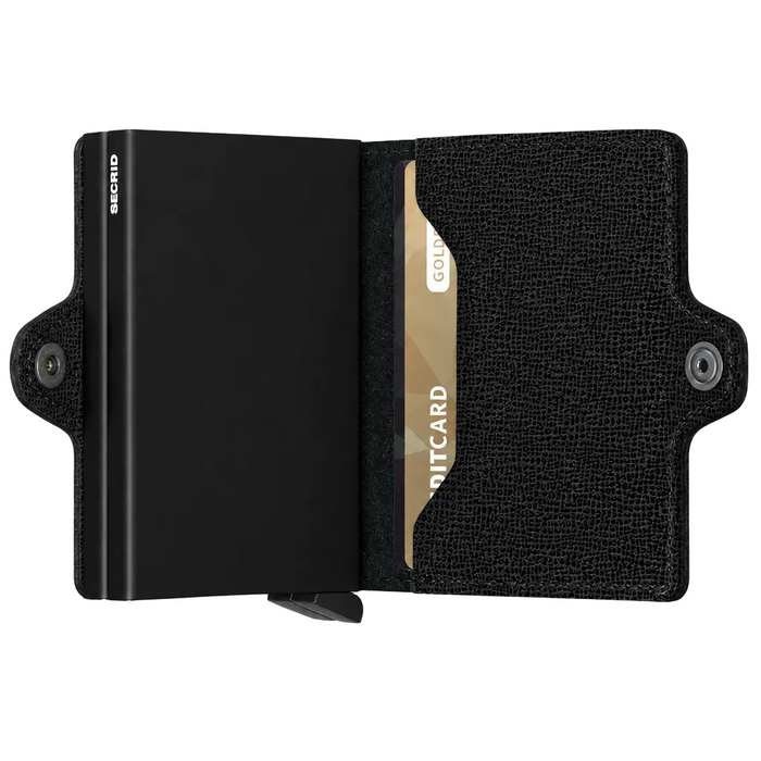 A black textured leather Secrid cardholder wallet shown open, with two slim black metal cardholders, and the brand name 'SECRID' visible on the left side of the wallet. 