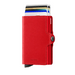 A red leather Secrid Twinwallet card holder with several cards partially visible inside the card protector.