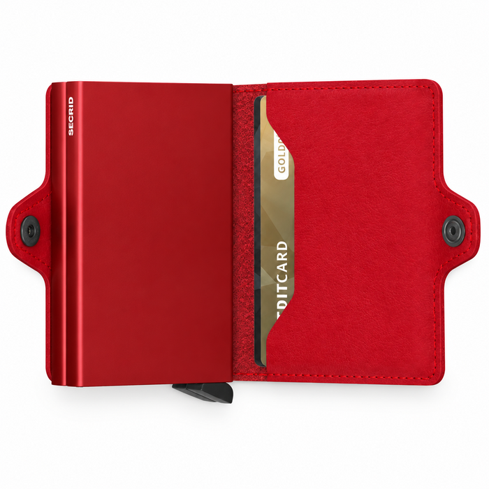 A red minimalist metal cardholder Secrid Twin wallet shown open, with its two card protectors, a pocket to hold cards, and a snap button.