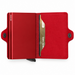 A red minimalist metal cardholder Secrid Twin wallet shown open, with its two card protectors, a pocket to hold cards, and a snap button.