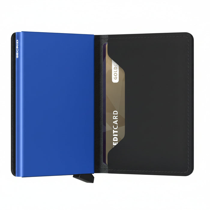 A minimalist metal cardholder wallet shown open on a white background, featuring a vibrant blue front cover, a black leather interior, and a gold-toned credit card inserted in the slot.