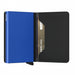 A minimalist metal cardholder wallet shown open on a white background, featuring a vibrant blue front cover, a black leather interior, and a gold-toned credit card inserted in the slot.