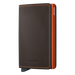A slim wallet with a matte truffle brown finish and an orange accent. The brand 'Secrid' is visible on the wallet.