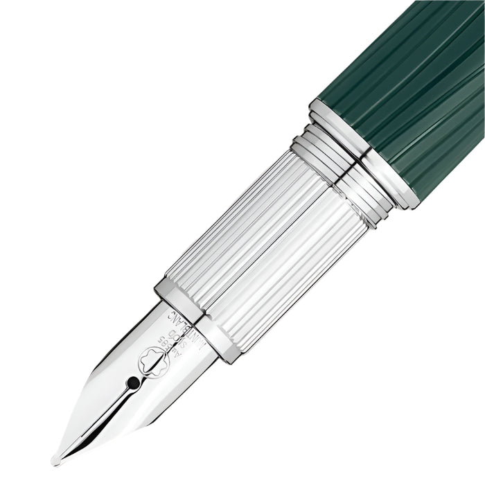 Fountain pen with green barrel and silver clip on a light beige background