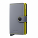 A gray leather wallet with a bright yellow-green side accent and matching contrast stitching, featuring a snap-button strap closure and the SECRID logo, shown on a plain white background.
