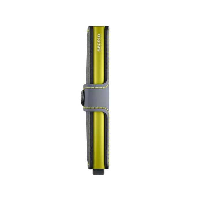 A slim Secrid wallet shown in a side profile view on a clean white background. The wallet features a vibrant yellow-green body with a gray strap closure and yellow stitching, with the brand name 'SECRID' printed vertically on the side.