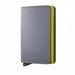A Secrid minimalist metal wallet in gray with bright yellow-green stitching and a matching yellow-green side frame, shown on a plain white background.