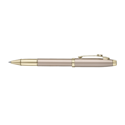 A sleek Sheaffer 100  Emily in Paris rollerball pen in a metallic champagne gold lacquer finish with champagne gold  trims and adorned with a bow-shaped emblem on the clip. Model E1937751