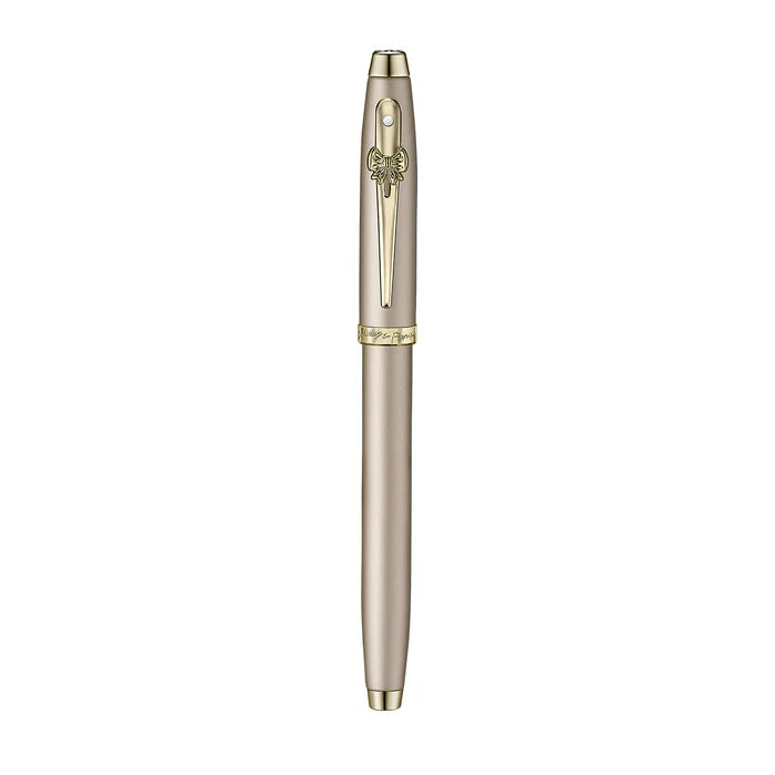 A sleek Sheaffer 100  Emily in Paris rollerball pen in a metallic champagne gold lacquer finish with champagne gold  trims and adorned with a bow-shaped emblem on the clip. Model E1937751