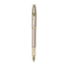 A sleek Sheaffer 100  Emily in Paris fountain pen in a metallic champagne gold lacquer finish with champagne gold  trims and adorned with a bow-shaped emblem on the clip . Model E0937753