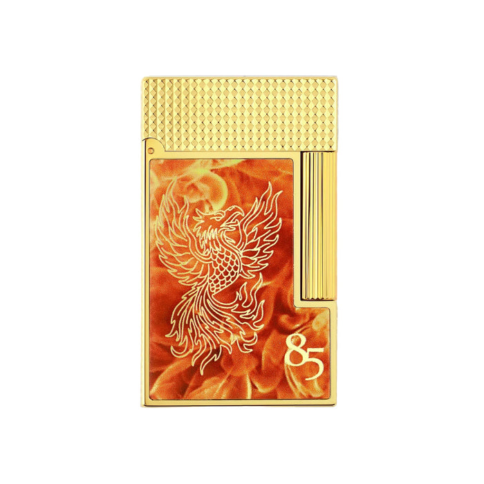 A gold S. T. Dupont lighter with a guilloche-finish gold plated top, and a front panel featuring an engraved-phoenix design over a fiery orange lacquer finish, with the number 85 on the lower right to celebrate the anniversary of the first Dupont Lighter ever made.