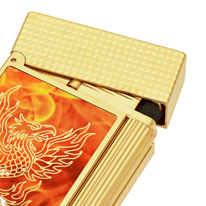 Close-up of a gold plated S. T. Dupont lighter with a guilloche-gold finish lid and a phoenix design engraved on an orange-flame pattern.
