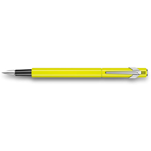 A fluorescent yellow Caran d'Ache 849 fountain pen with a stainless steel nib and a click-in cap.